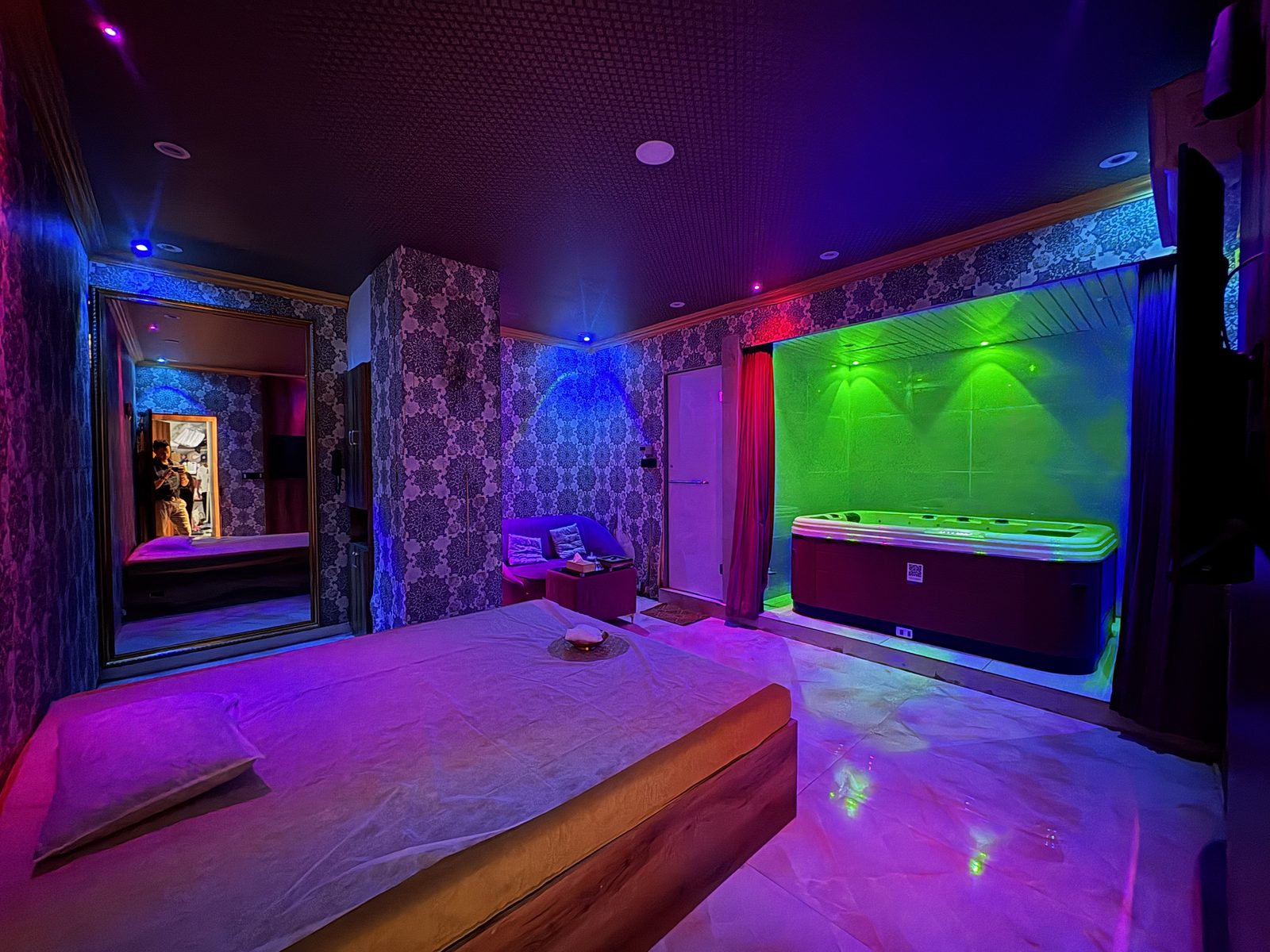 Private suite with massage bed and Jacuzzi under mood lighting