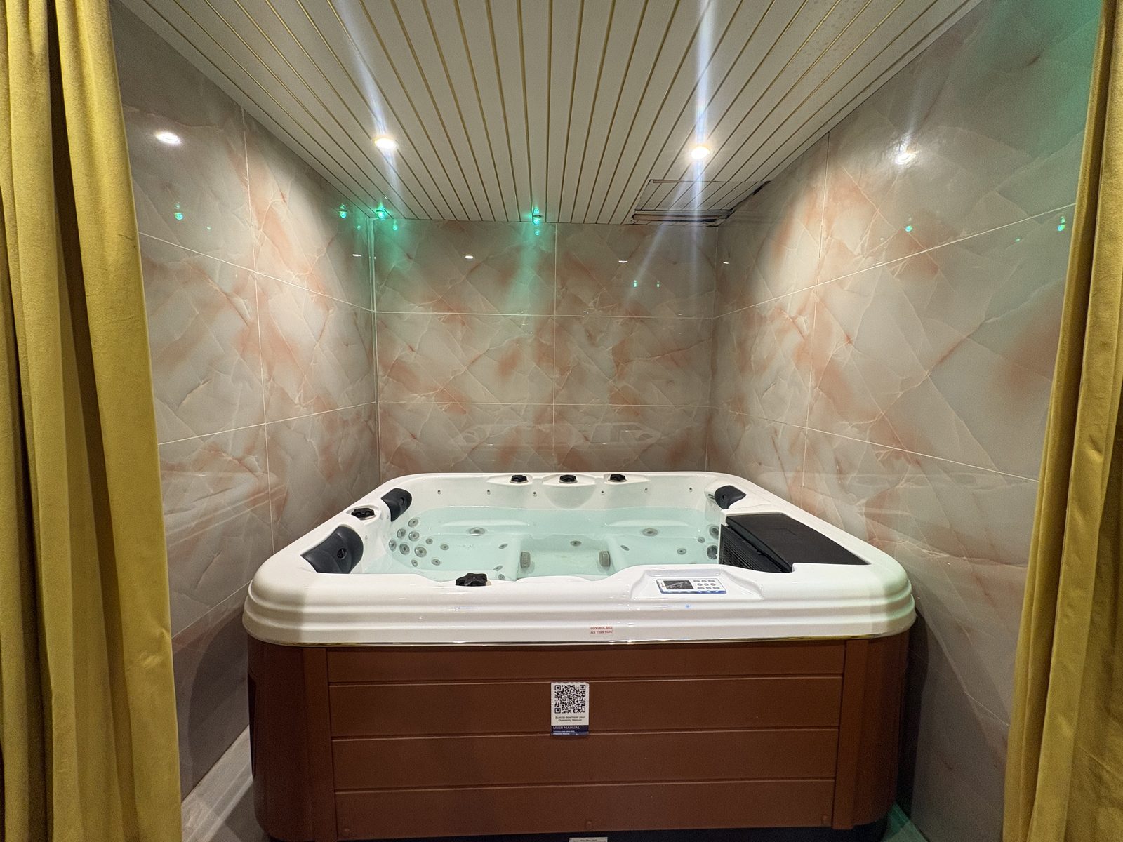 Jacuzzi framed by gold curtains
